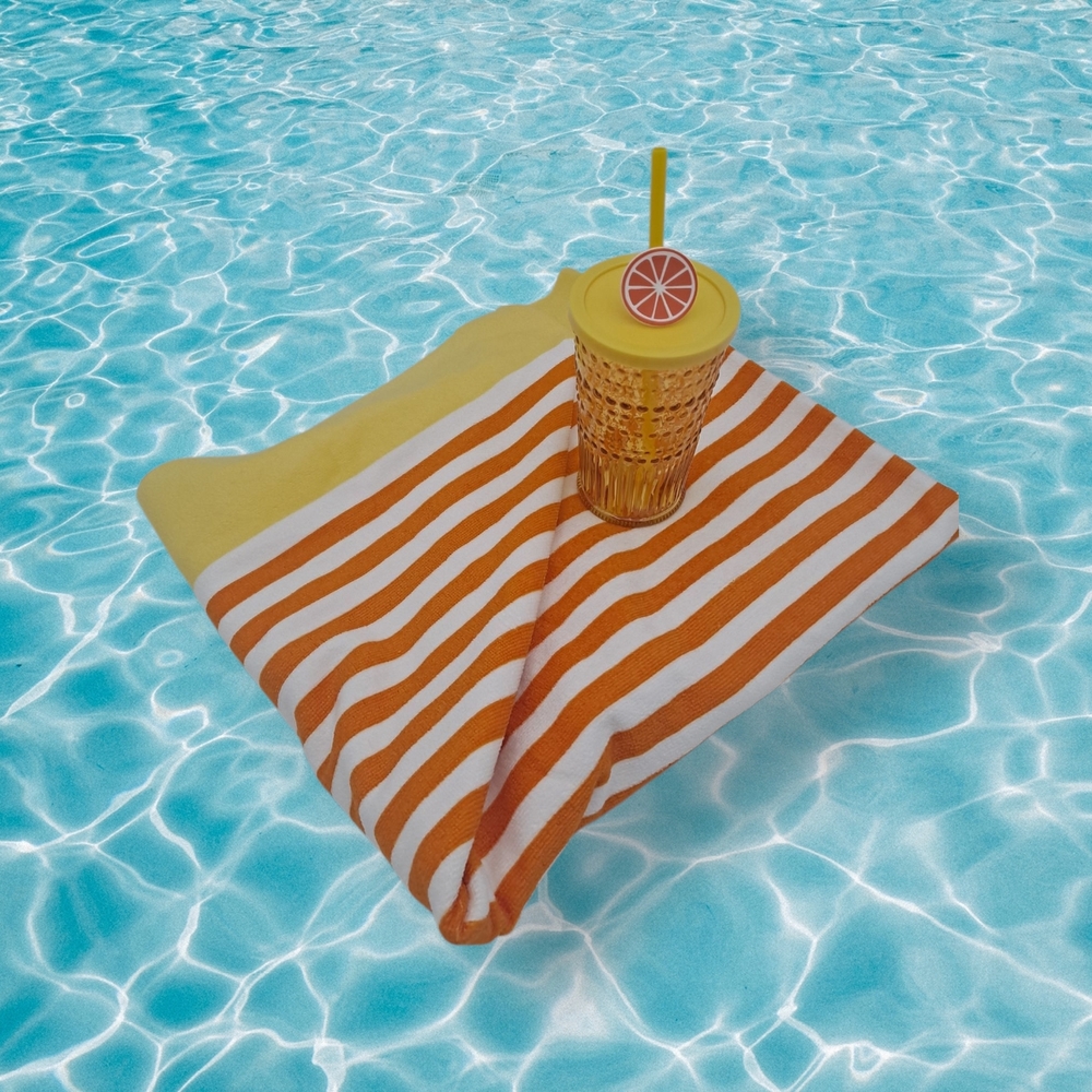 Striped Orange, Yellow, and White Beach Towel & Yellow Glass Tumbler